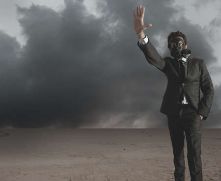 Businessman indicates radiation hazard in a desertの写真素材