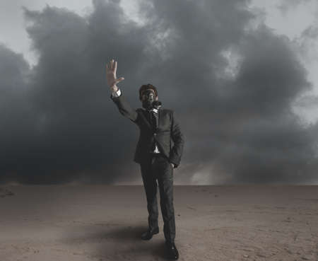 Businessman indicates radiation hazard in a desertの写真素材