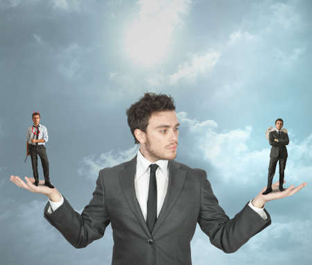 Businessman must choose between the devil or angelの写真素材
