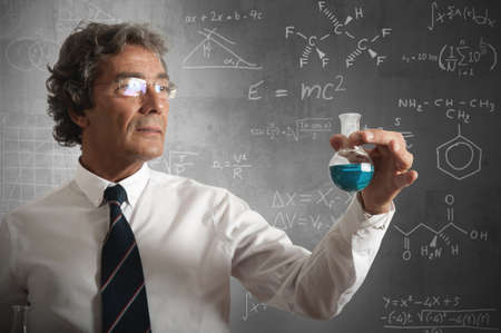 Businessman takes the chemical formula for the successの写真素材