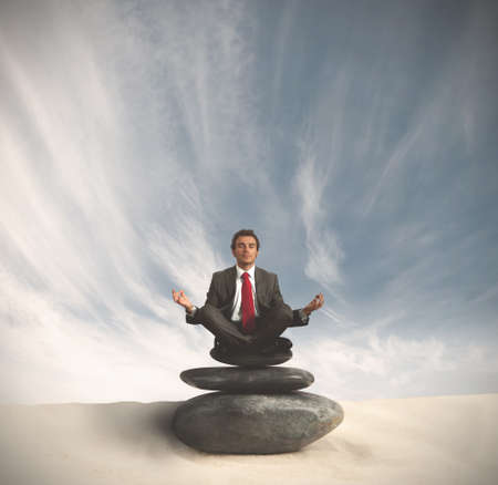 Business man relaxes on the stones spaの写真素材