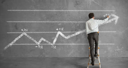 Businessman draws a statistical trend lineの写真素材