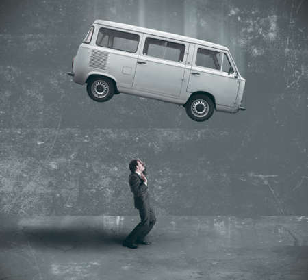 Businessman afraid of being crushedの写真素材