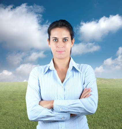 Positive businesswoman in a green fieldの写真素材