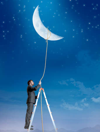 Concept of a businessman that wants the moonの写真素材