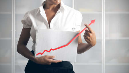 Businesswoman helps statistics trend to growthの写真素材