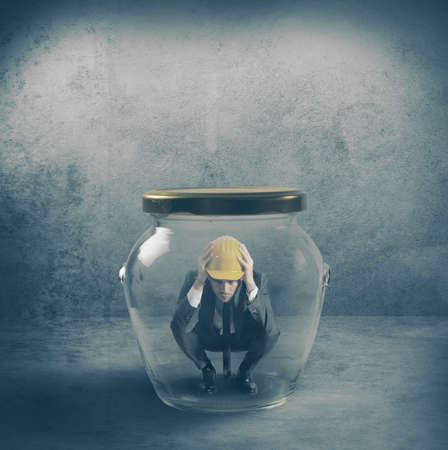 Scared businessman in a jarの写真素材