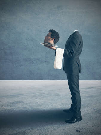 Businessman surrenders handing the headの写真素材