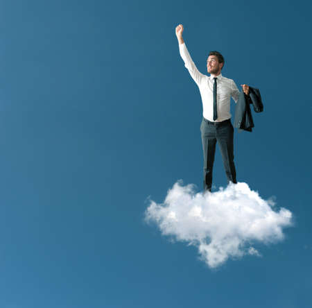 Success of a businessman over a cloudの写真素材