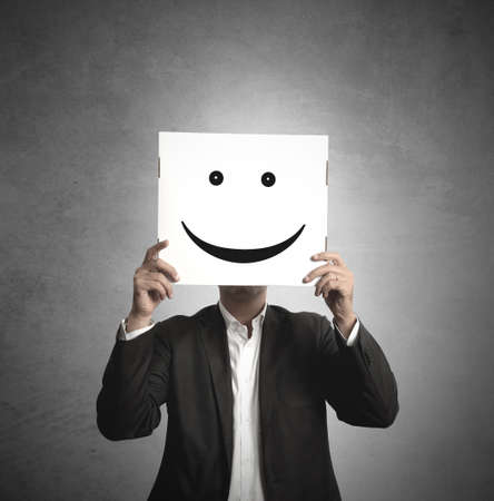 Businessman holds a paper with a smileの写真素材