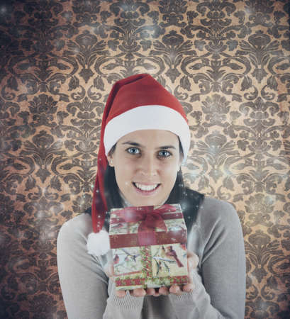 Beautiful girl showing a Christmas presentの写真素材