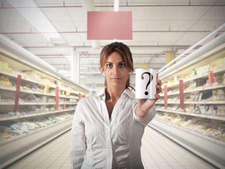 Girl at supermarket that show an unknow productの写真素材