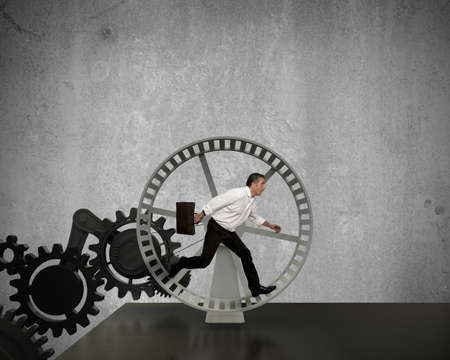 Businessman running in a business power generatorの写真素材