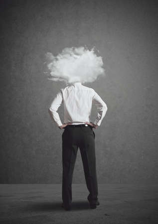 Concept of businessman with head in the cloudsの写真素材