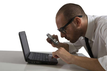 Businessman  looks on the computer with a magnifying glassの写真素材