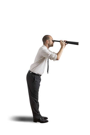 Businesswoman with telescope on white backgroundの写真素材