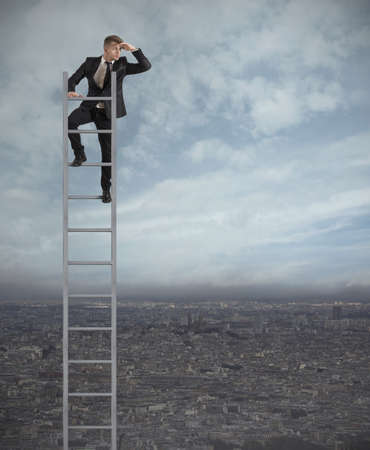 Businessman looking the future on a stairsの写真素材