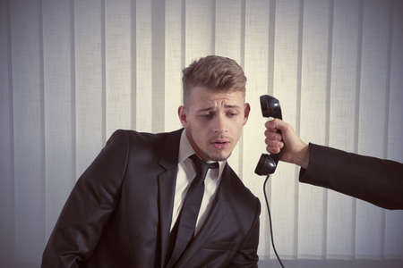 Concept of businessman surprised by a callの写真素材