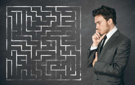 Businessman seek the solution of a complex mazeの写真素材