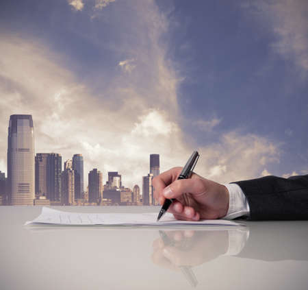 Businessman is signing a contract in office