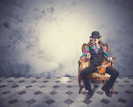 Young violinist man in a vintage roomの写真素材