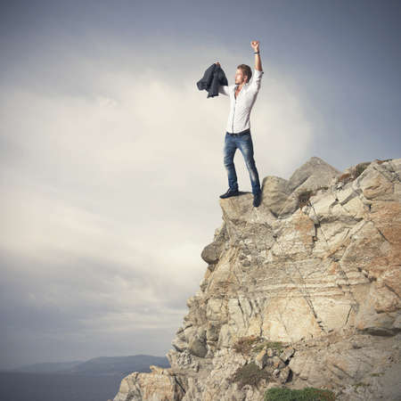 Successful business man on a mountainの写真素材
