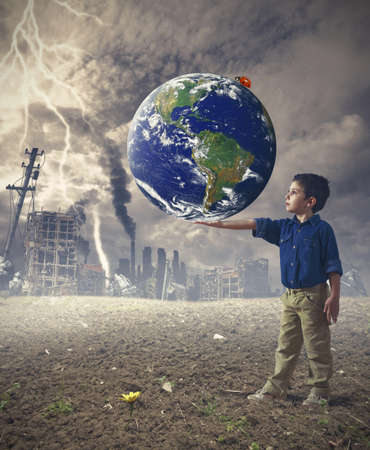 Young boy holds the word. Concept of save the worldの写真素材