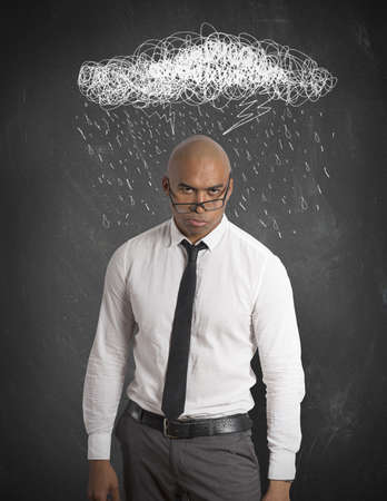 Stressed businessman with drawing of cloud and rainの写真素材