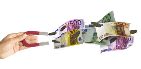 Magnet attracts many banknotes and moneyの写真素材