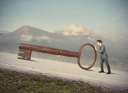 Businessman with big key to successの写真素材