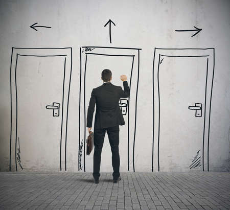 Businessman opens a door designed in a wallの写真素材