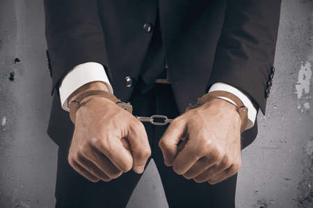 Concept of handcuffed businessman in jailの写真素材