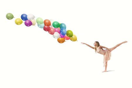 Young girl dance with colorful balloonsの写真素材