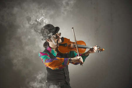 Violinist with pipe surrounded by smokeの写真素材