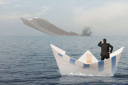 Ship is sinking into the sea. Concept of business crisisの写真素材
