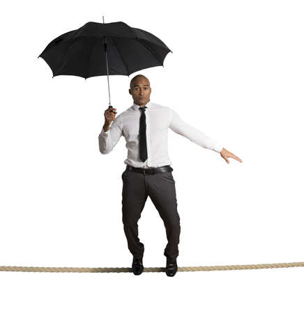 Concept of risk in business with businessman on the ropeの写真素材