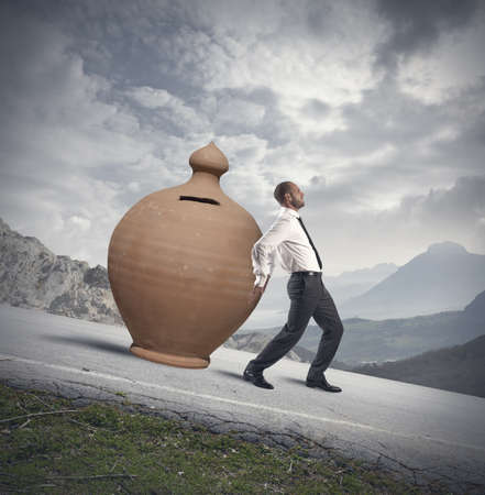 Concept of Savings protection with moneybox and businessmanの写真素材