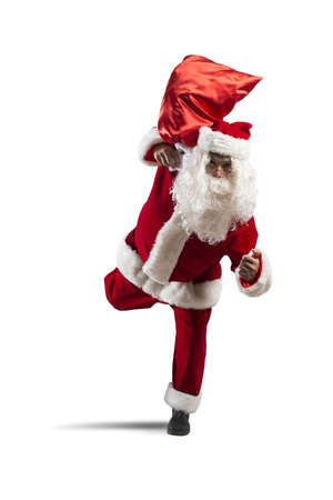 Running Santa Claus with sack of giftsの写真素材