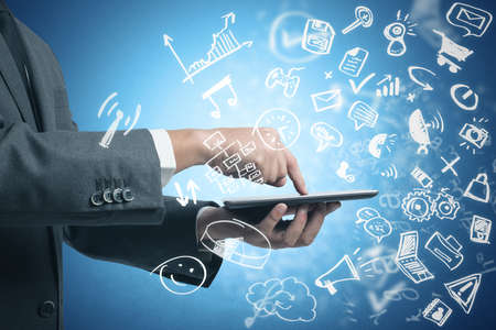 Businessman working with tablet and social media with modern sketch symbolの写真素材
