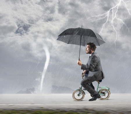 Concept of escape from crisis with businessman on bike