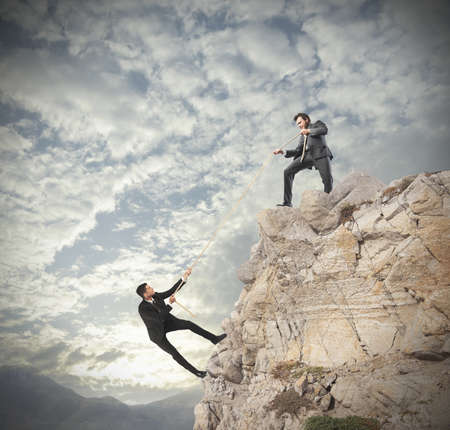 Concept of teamwork with climbing businessmanの写真素材