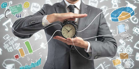 Concept of time is money with businessman and clockの写真素材
