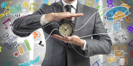 Concept of time is money with businessman and clockの写真素材