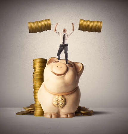 Concept of earning of a businessman who raises money as weightsの写真素材