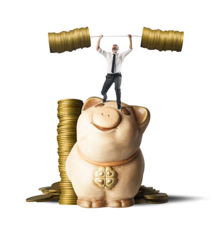 Concept of earning of a businessman who raises money as weightsの写真素材