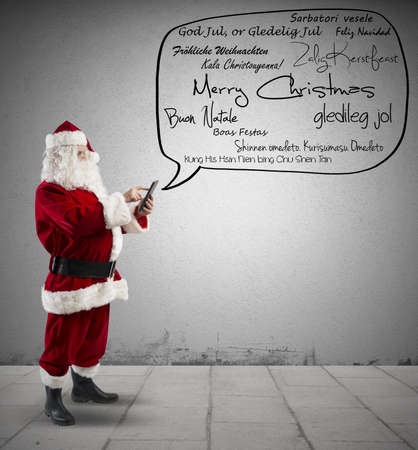 Santa Claus with Merry Christmas message in various languageの写真素材