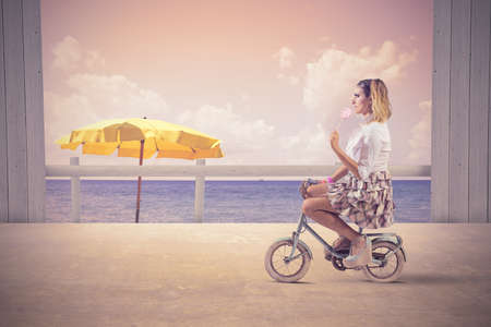 Concept of summer fashion with girl on the bikeの写真素材