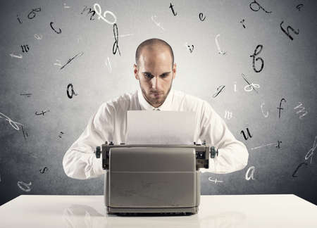 Businessman working with an old typewriterの写真素材