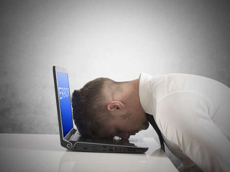 Businessman with blue screen of laptop errorの写真素材