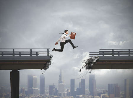 Businessman solves the problem of a broken bridgeの写真素材